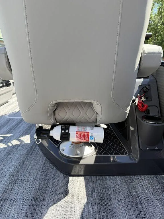 Slide: The Image of 2026 Bennington M Swingback 24 MSB boat interior with covered seating and storage area. - 23