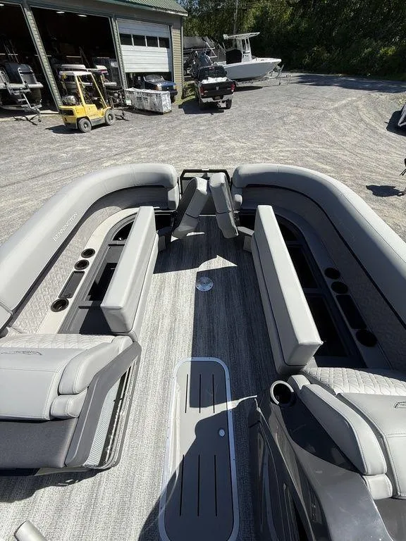 Slide: The Image of 2026 Bennington M Swingback 24 MSB boat interior with sleek flooring and seating. - 29