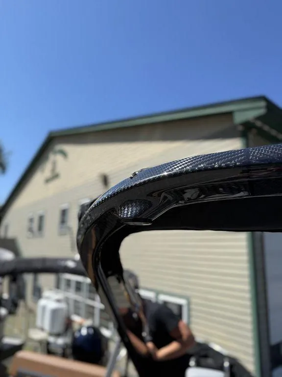 Slide: The Image of 2026 Bennington M Swingback 24 MSB boat detail with building in background. - 31