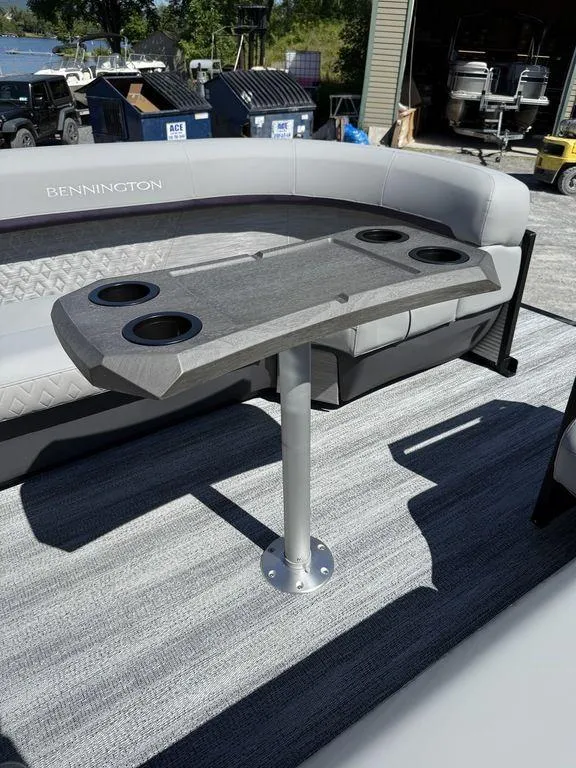 Slide: The Image of 2026 Bennington M Swingback 24 MSB boat interior with table and cup holders. - 32