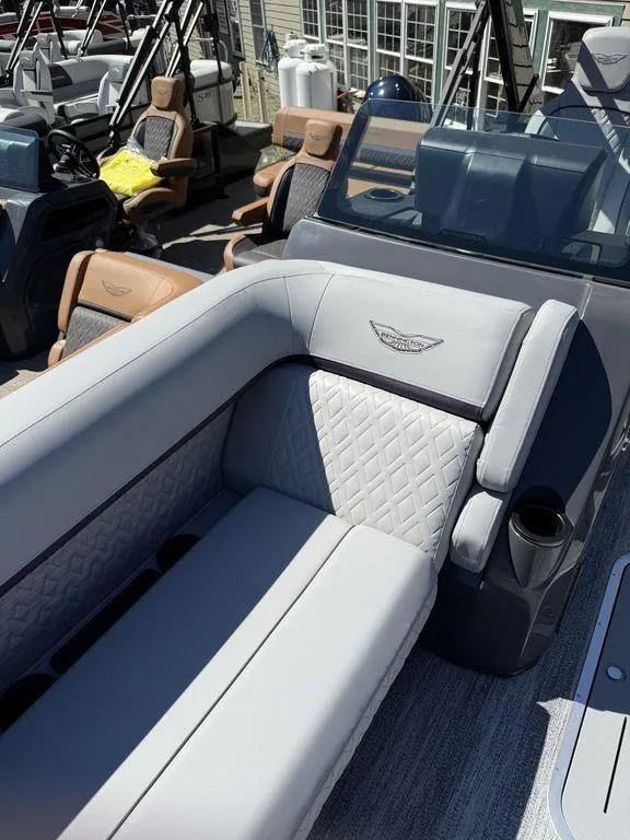 Slide: The Image of 2026 Bennington M Swingback 24 MSB boat detail with clear blue sky background. - 33