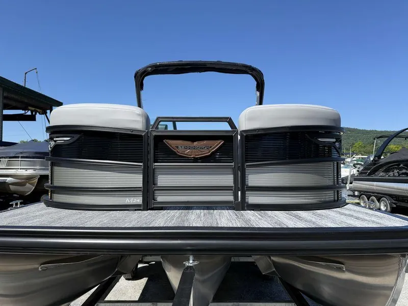 Slide: The Image of 2026 Bennington M Swingback 24 MSB boat detail against clear blue sky. - 6