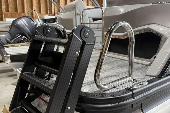 Slide: The Image of 2026 Bennington RX Sport Quad Bench 23 RXFB boat with ladder and seating area. - 13
