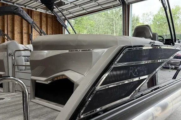 Slide: The Image of 2026 Bennington RX Sport Quad Bench 23 RXFB pontoon boat in a garage setting. - 14