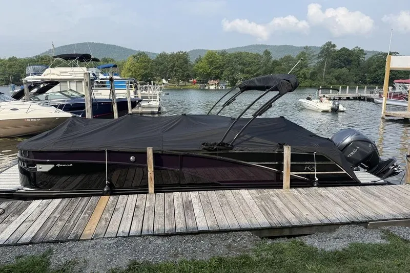 Slide: The Image of 2026 Bennington RX Sport Quad Bench 23 RXFB pontoon boat docked with cover on. - 16