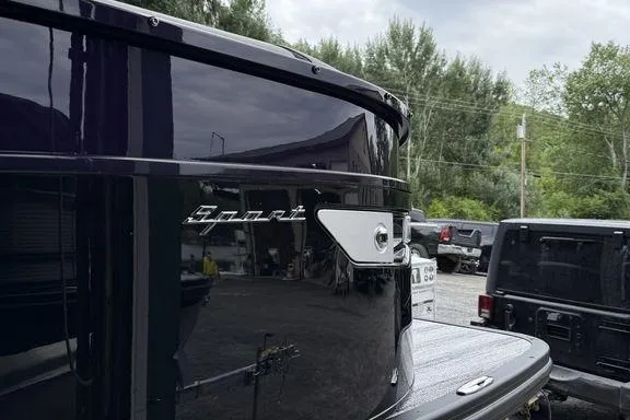 Slide: The Image of 2026 Bennington RX Sport Quad Bench 23 RXFB boat, sleek design, parked outdoors. - 18