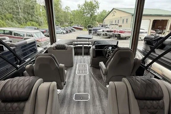 Slide: The Image of Interior of 2026 Bennington RX Sport Quad Bench 23 RXFB pontoon boat, featuring luxurious seating. - 19