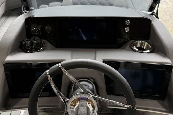 Slide: The Image of 2026 Bennington RX Sport Quad Bench 23 RXFB dashboard with modern steering and controls. - 26