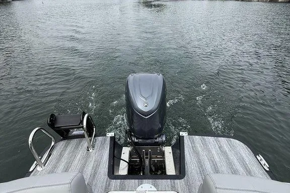 Slide: The Image of 2026 Bennington RX Sport Quad Bench 23 RXFB pontoon boat on water, rear view. - 5