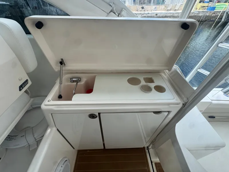 Slide: The Image of 2006 Tiara Yachts 4200 Open, cockpit sink and storage area with cup holders. - 20