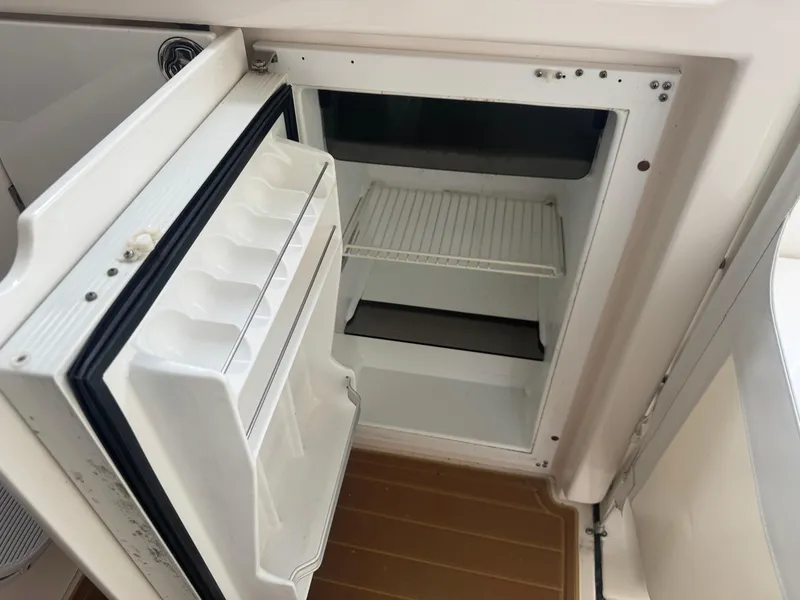 Slide: The Image of Open refrigerator on 2006 Tiara Yachts 4200 Open, showcasing interior shelves and door compartments. - 21