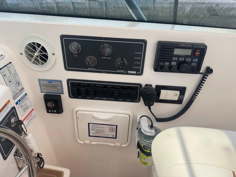 Slide: The Image of Control panel of a 2006 Tiara Yachts 4200 Open, featuring gauges and communication equipment. - 24