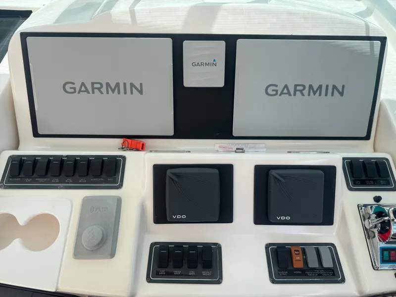 Slide: The Image of Control panel of a 2006 Tiara Yachts 4200 Open with Garmin displays and switches. - 26