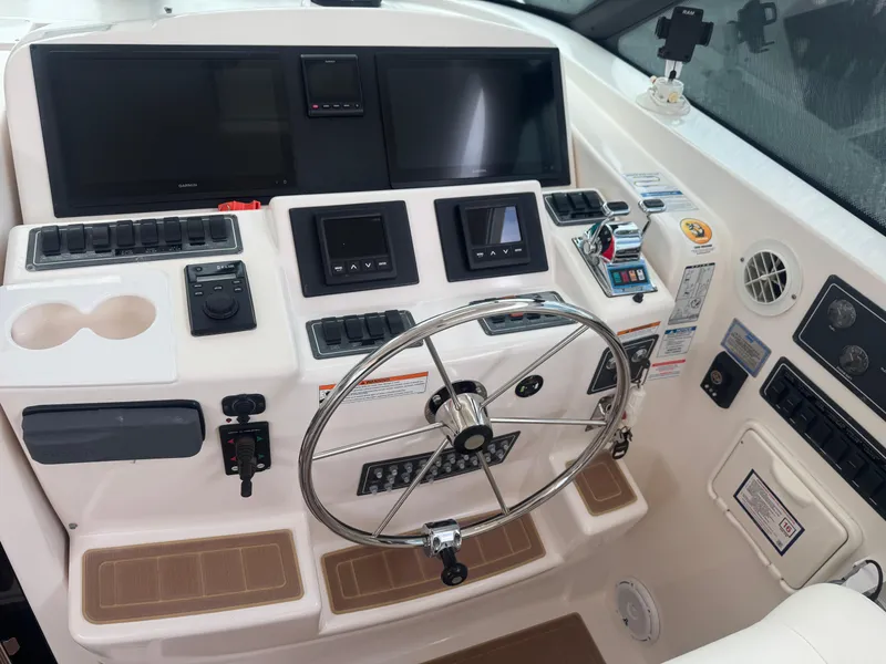 Slide: The Image of Helm of 2006 Tiara Yachts 4200 Open with steering wheel and navigation controls. - 28