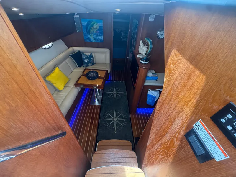 Slide: The Image of Luxurious interior of 2006 Tiara Yachts 4200 Open with cozy seating and nautical decor. - 32
