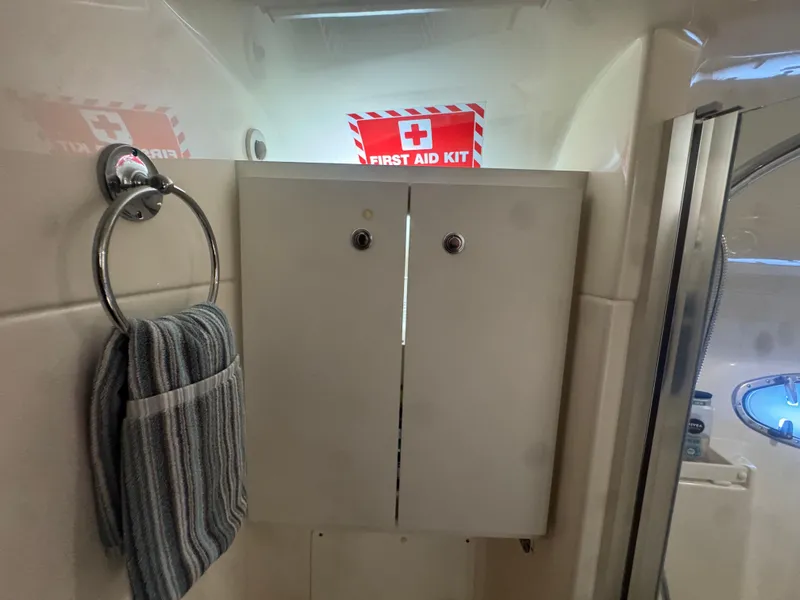 Slide: The Image of Bathroom interior of 2006 Tiara Yachts 4200 Open with first aid kit and towel. - 41