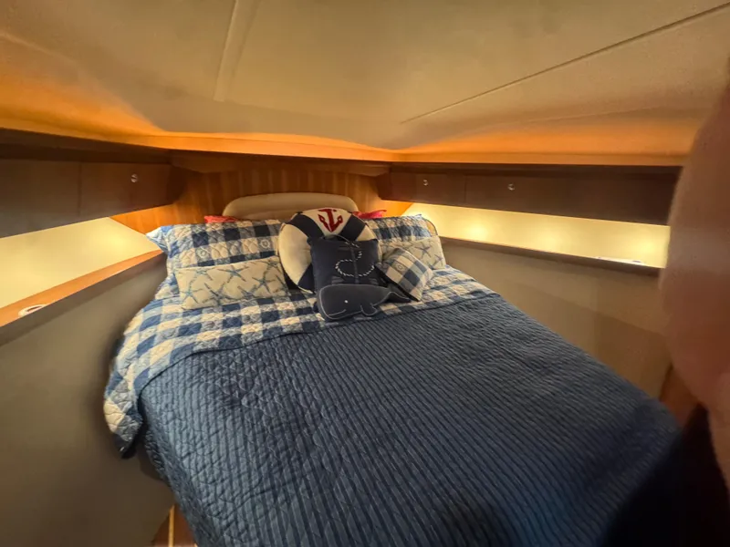 Slide: The Image of Cozy cabin interior of 2006 Tiara Yachts 4200 Open with quilted bedding and soft lighting. - 45