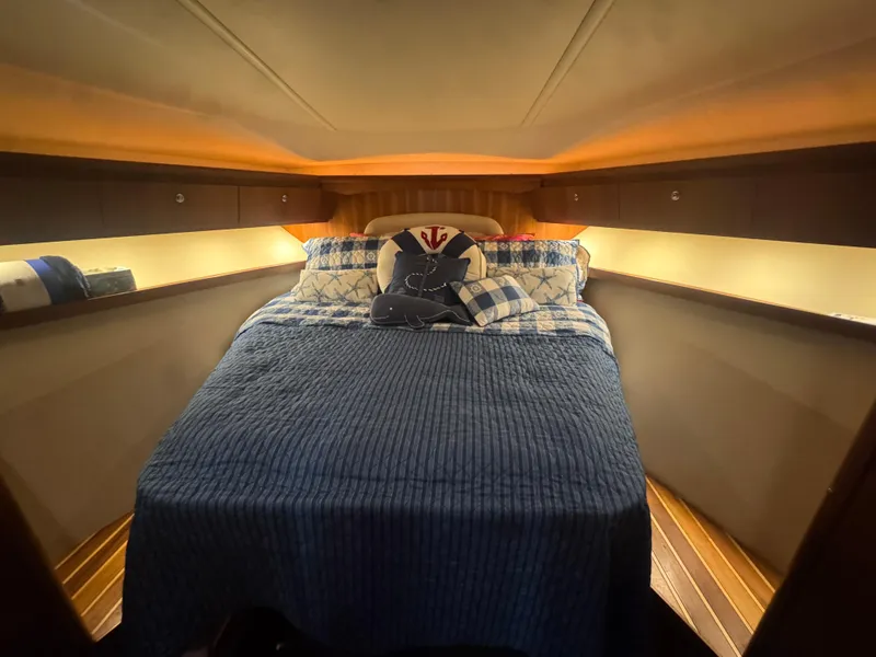 Slide: The Image of Cozy cabin interior of 2006 Tiara Yachts 4200 Open with nautical-themed bedding. - 46
