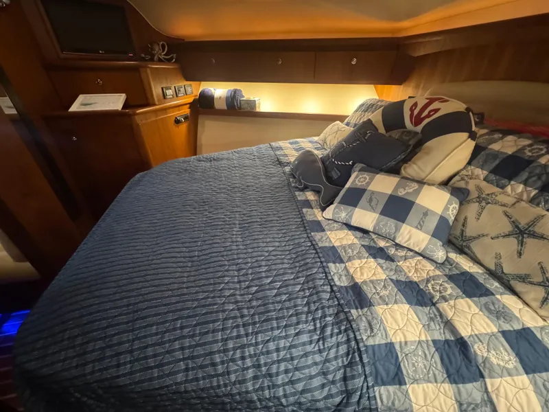 Slide: The Image of Cozy cabin interior of 2006 Tiara Yachts 4200 Open with nautical-themed bedding. - 47