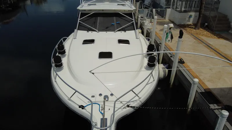 Slide: The Image of 2006 Tiara Yachts 4200 Open docked, showcasing sleek design and spacious deck. - 7