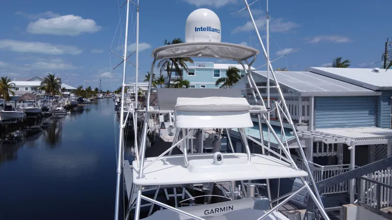 Slide: The Image of 2006 Tiara Yachts 4200 Open docked in a scenic canal with clear skies. - 8