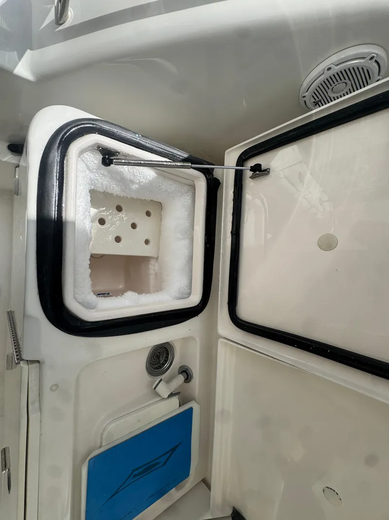 Slide: The Image of 2006 Tiara Yachts 4200 Open interior storage compartment with open hatch and speaker. - 9