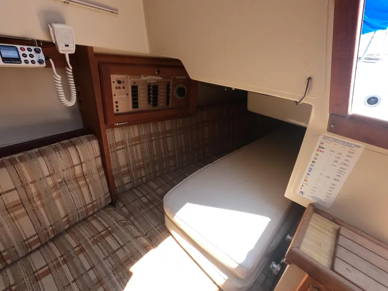 Slide: The Image of Interior of a 1985 Catalina 27 sailboat with control panel and seating area. - 11
