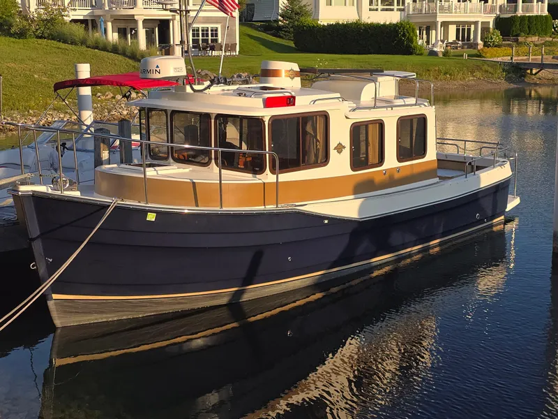 The Image of 2017 Ranger Tugs R-27 boat docked in a serene waterfront setting. - 0