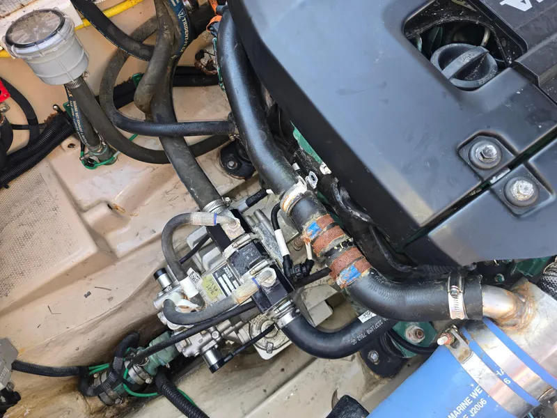 Slide: The Image of Engine compartment of a 2017 Ranger Tugs R-27 boat, showing hoses and components. - 11