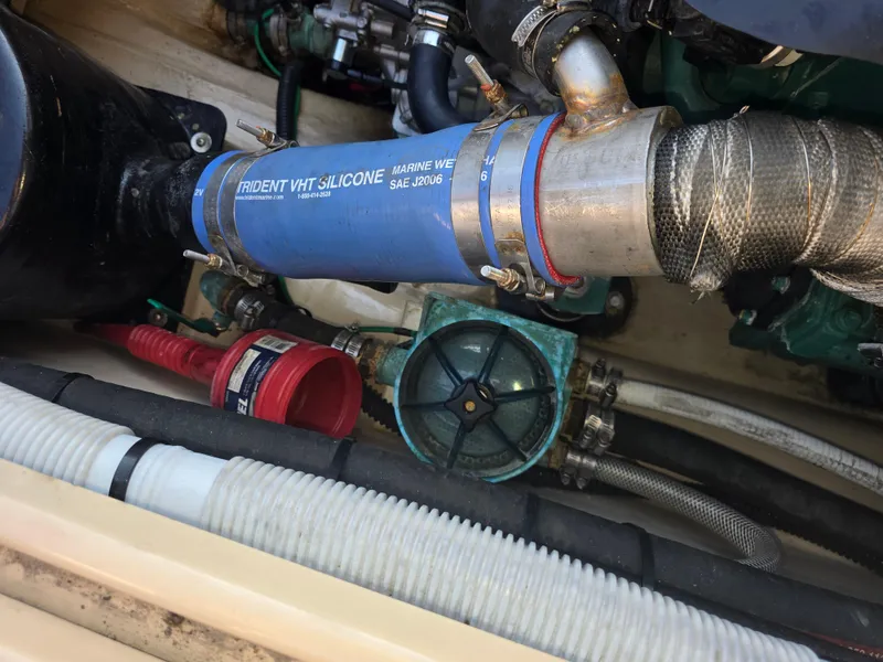 Slide: The Image of Engine compartment of a 2017 Ranger Tugs R-27 with visible silicone hose and components. - 13