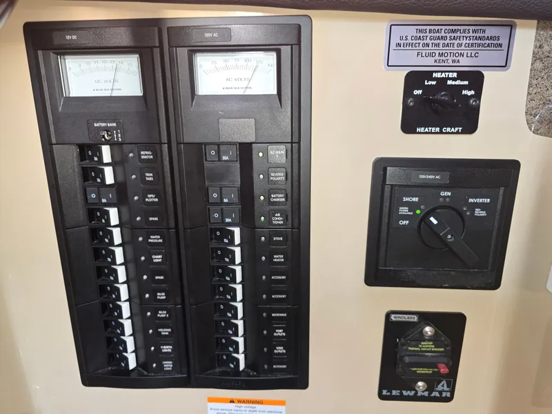 Slide: The Image of Control panel of a 2017 Ranger Tugs R-27 boat, featuring AC/DC switches and voltage meters. - 15
