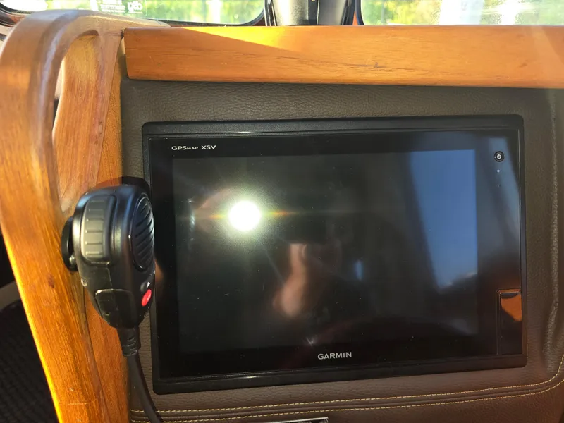 Slide: The Image of Garmin GPSMAP XSV on 2017 Ranger Tugs R-27 dashboard with microphone attached. - 16