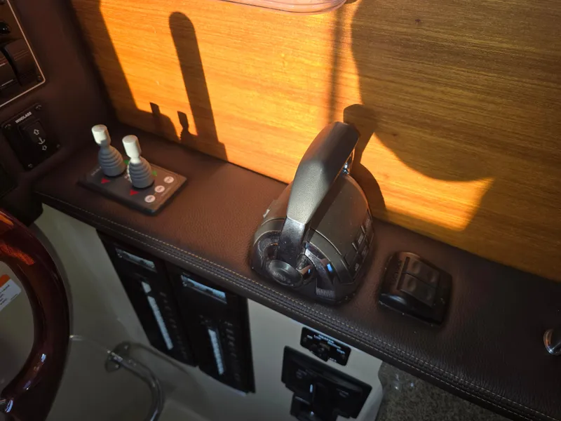 Slide: The Image of Control panel of a 2017 Ranger Tugs R-27 boat with throttle and switches. - 18