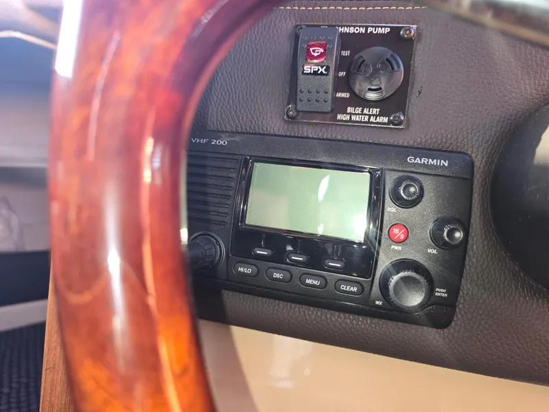 Slide: The Image of Garmin VHF 200 radio and bilge alarm on 2017 Ranger Tugs R-27 dashboard. - 19