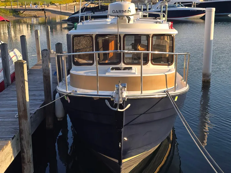 Slide: The Image of 2017 Ranger Tugs R-27 boat docked at marina, front view with Garmin equipment. - 2