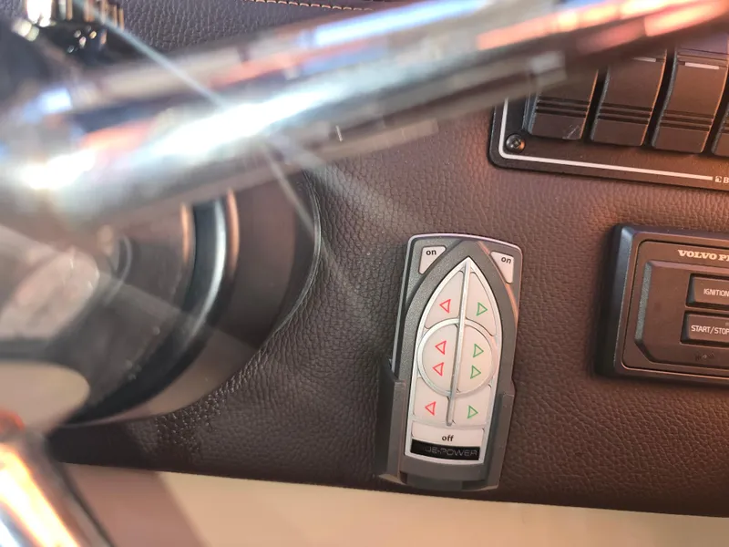 Slide: The Image of Control panel of a 2017 Ranger Tugs R-27 boat with steering wheel and buttons. - 20