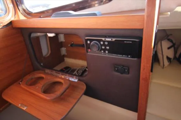Slide: The Image of Interior of 2017 Ranger Tugs R-27 boat with wooden paneling and radio system. - 30