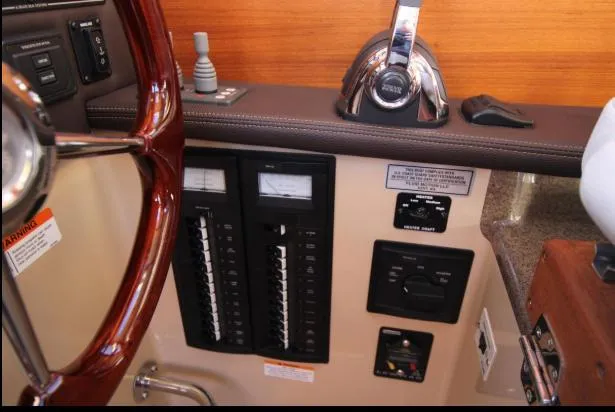 Slide: The Image of Control panel of a 2017 Ranger Tugs R-27 boat, featuring gauges and switches. - 32