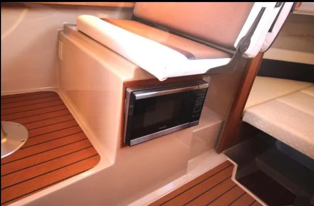 Slide: The Image of 2017 Ranger Tugs R-27 interior with microwave and wooden flooring. - 37