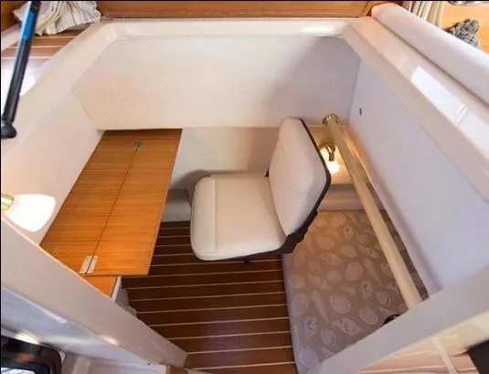 Slide: The Image of 2017 Ranger Tugs R-27 interior cabin with seating and wooden flooring. - 38