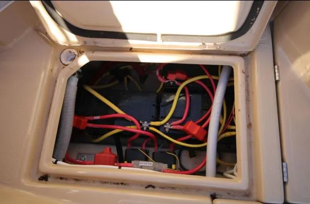 Slide: The Image of 2017 Ranger Tugs R-27 battery compartment with red and yellow cables. - 40