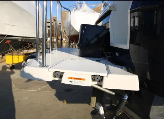 Slide: The Image of 2017 Ranger Tugs R-27 boat stern with swim platform and railing in a marina. - 46