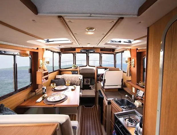 Slide: The Image of Manufacturer Provided Image: 2017 Ranger Tugs R-27 interior with dining area, kitchen, and helm station. - 51