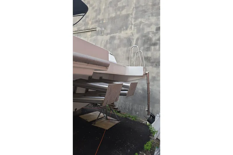 Slide: The Image of Rear view of a 2021 Giupex 33 boat with metal ladder and supports. - 12