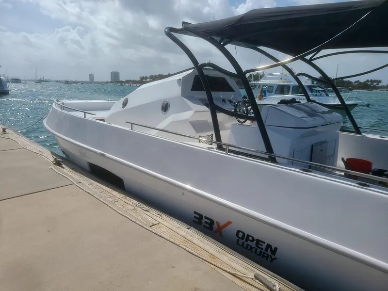 Slide: The Image of Luxury Giupex 33X boat docked, 2021 model, sleek design, sunny day, ocean backdrop. - 4