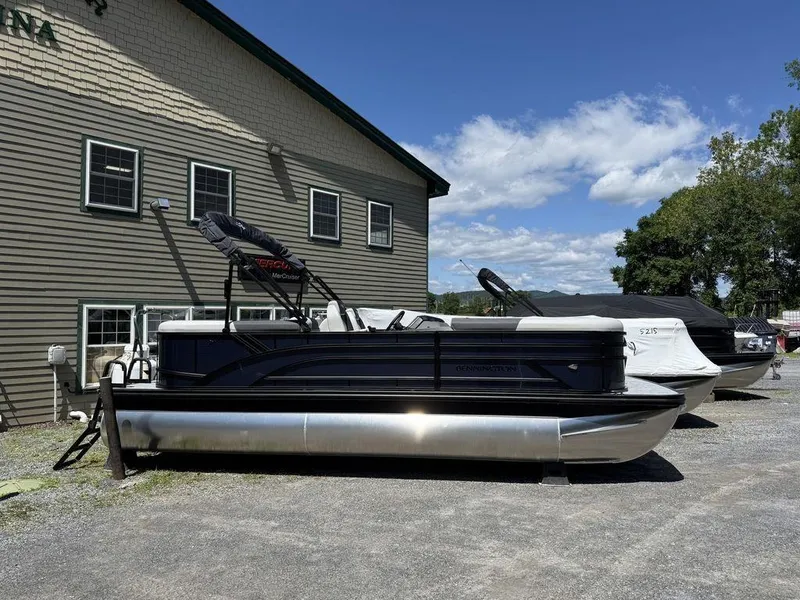 The Image of 2026 Bennington S Quad Bench 22 SSR pontoon boat parked outdoors on gravel. - 1