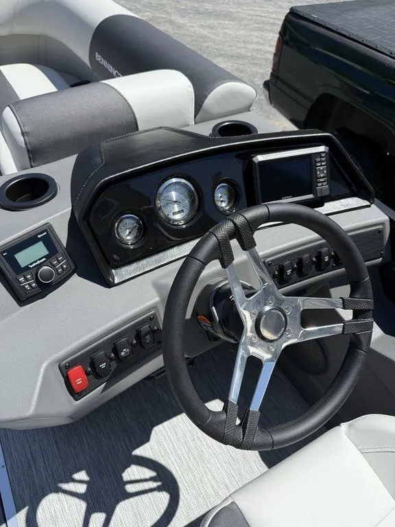 Slide: The Image of 2026 Bennington S Quad Bench 22 SSR boat dashboard with steering wheel and controls. - 12