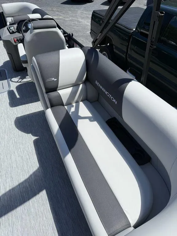 Slide: The Image of 2026 Bennington S Quad Bench 22 SSR boat interior with gray and white seating. - 15