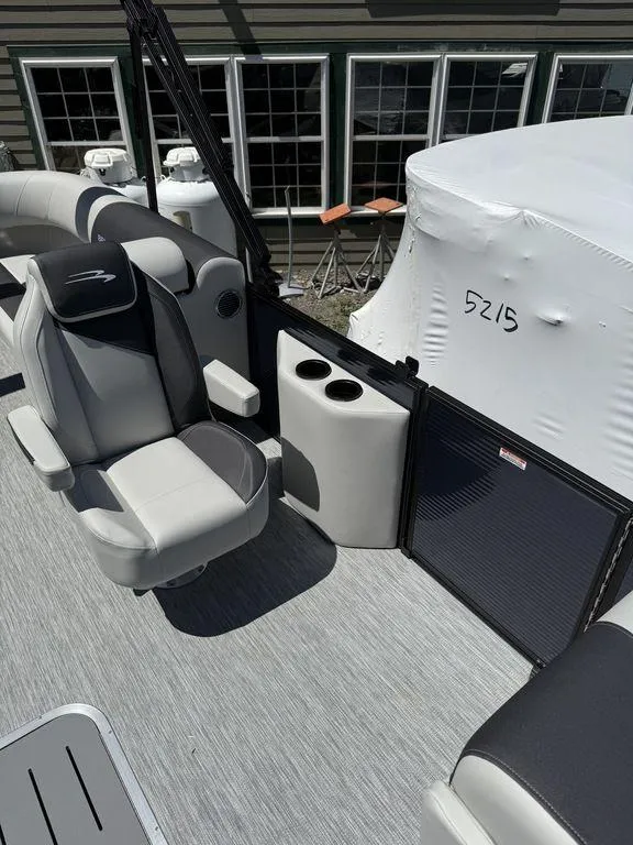 Slide: The Image of 2026 Bennington S Quad Bench 22 SSR boat interior with seating and cup holders. - 16
