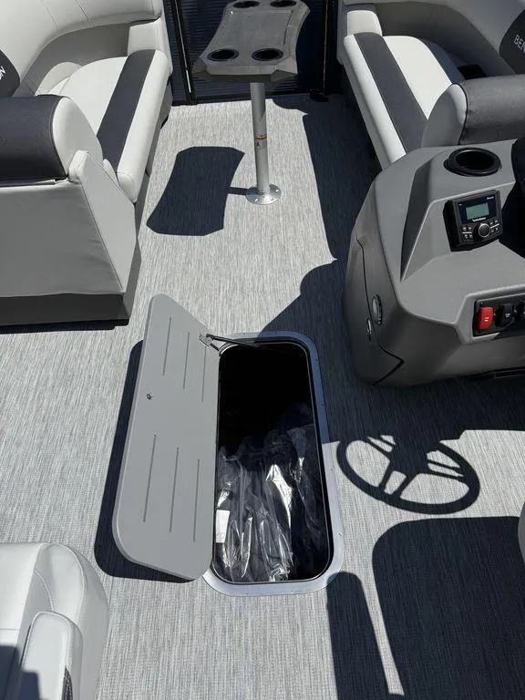 Slide: The Image of 2026 Bennington S Quad Bench 22 SSR interior with open storage compartment. - 19